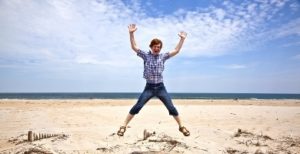 Kid jumping in the air at the beach