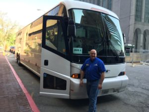 Bus driver standing in front of bus