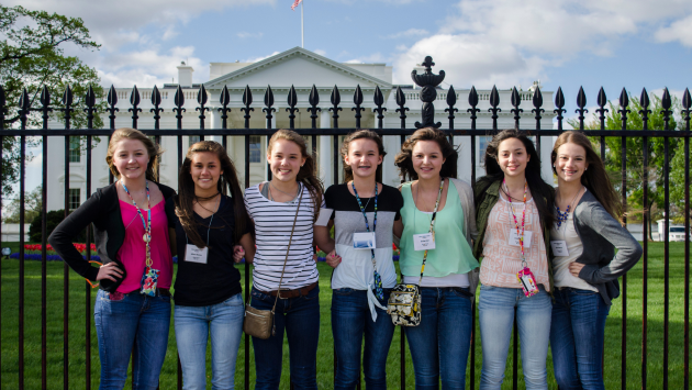 Group of female students standing together posting in front of the White House