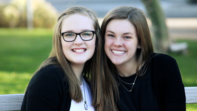 Two students smiling together