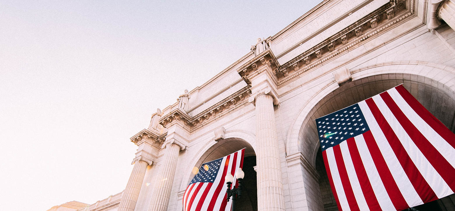 Building with American flags hanging down from arches