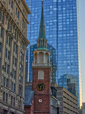 Old clocktower among skyscrapers