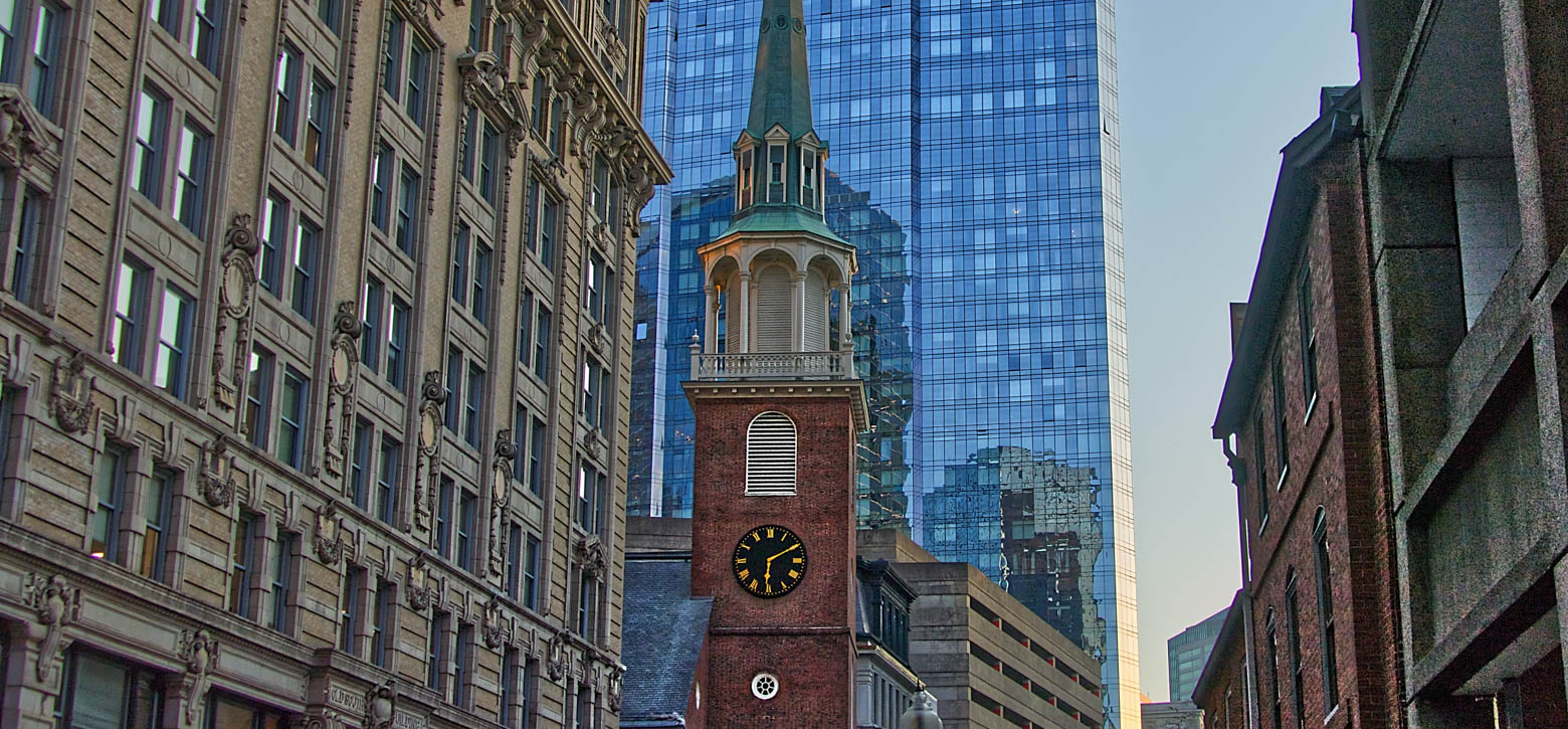 Old clocktower among skyscrapers