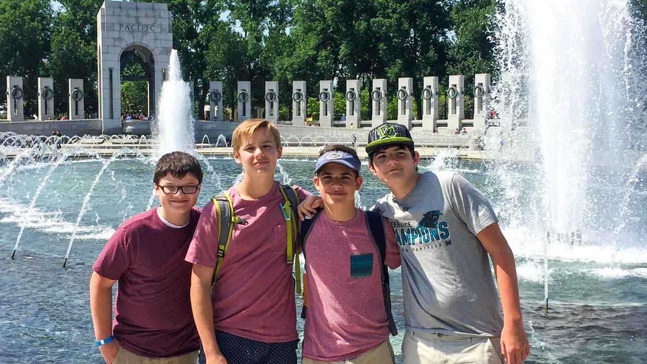 Four students in front of a fountain