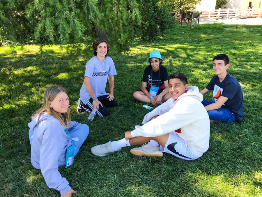 Students sitting in a grassy field