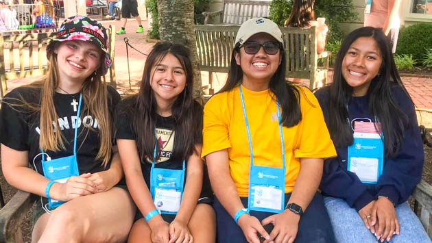 Four students sitting on a bench in Washington, D.C.