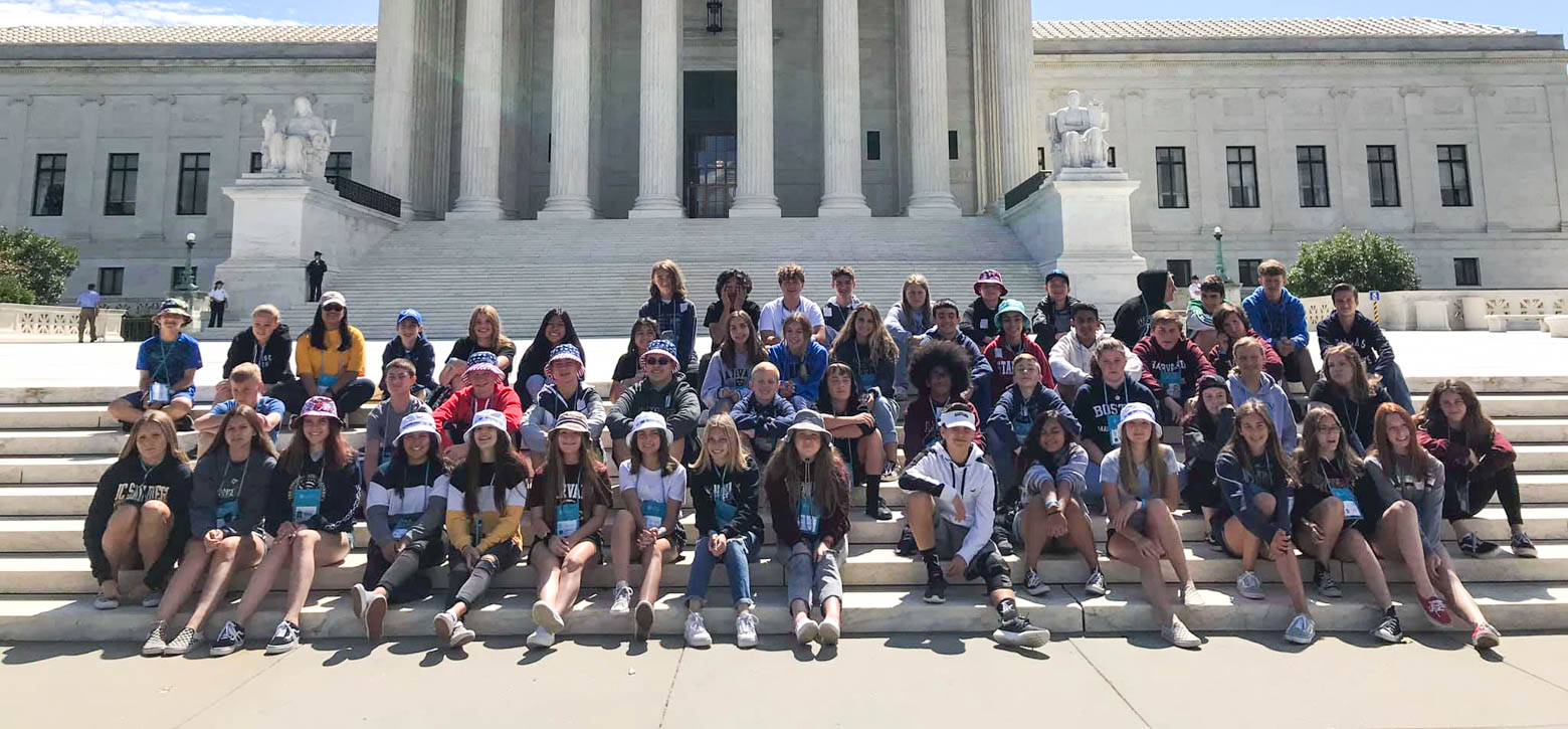 Large group of students gathered on the steps outside of the Lincoln Memorial