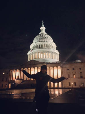 Student in front of the Capitol Building at night