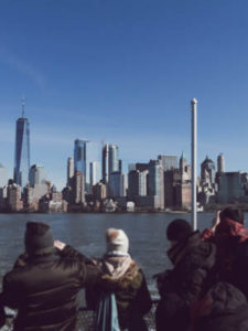 Group of travelers looking at the NYC skyline