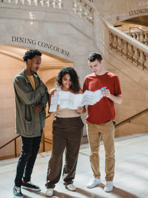 Group of students looking at a map in the Grand Central station