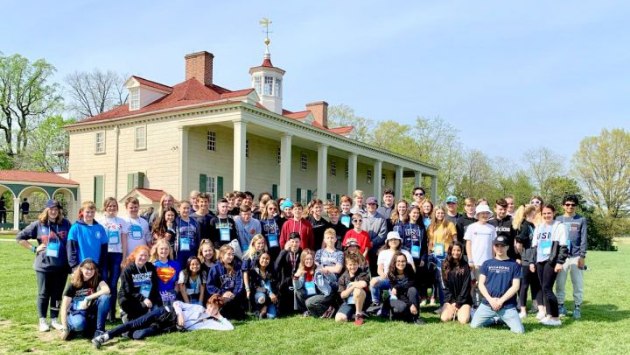 students on an educational tour posing in front on Mount Vernon